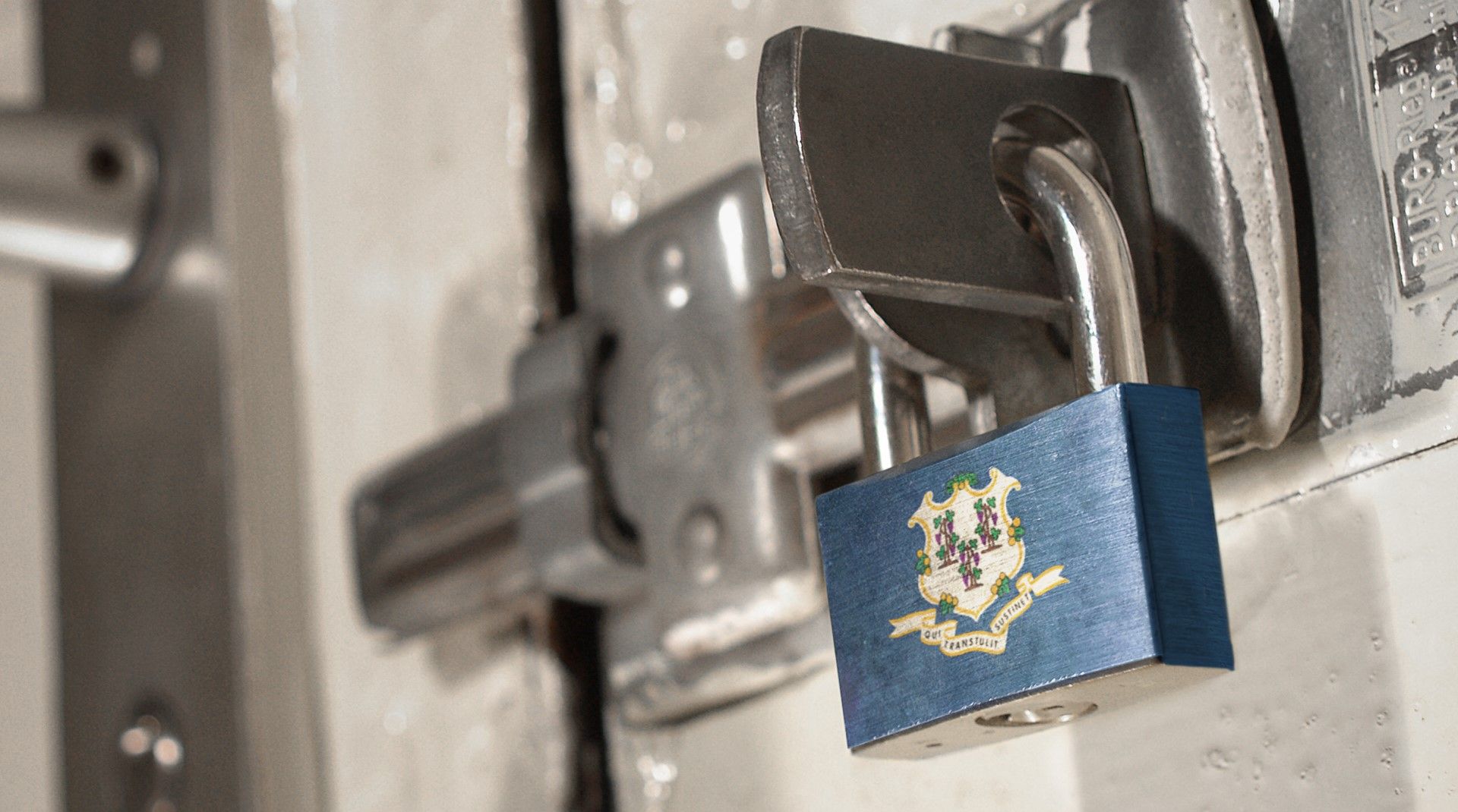 Padlock displaying the Connecticut state flag secured on a metal latch, symbolizing data privacy law.