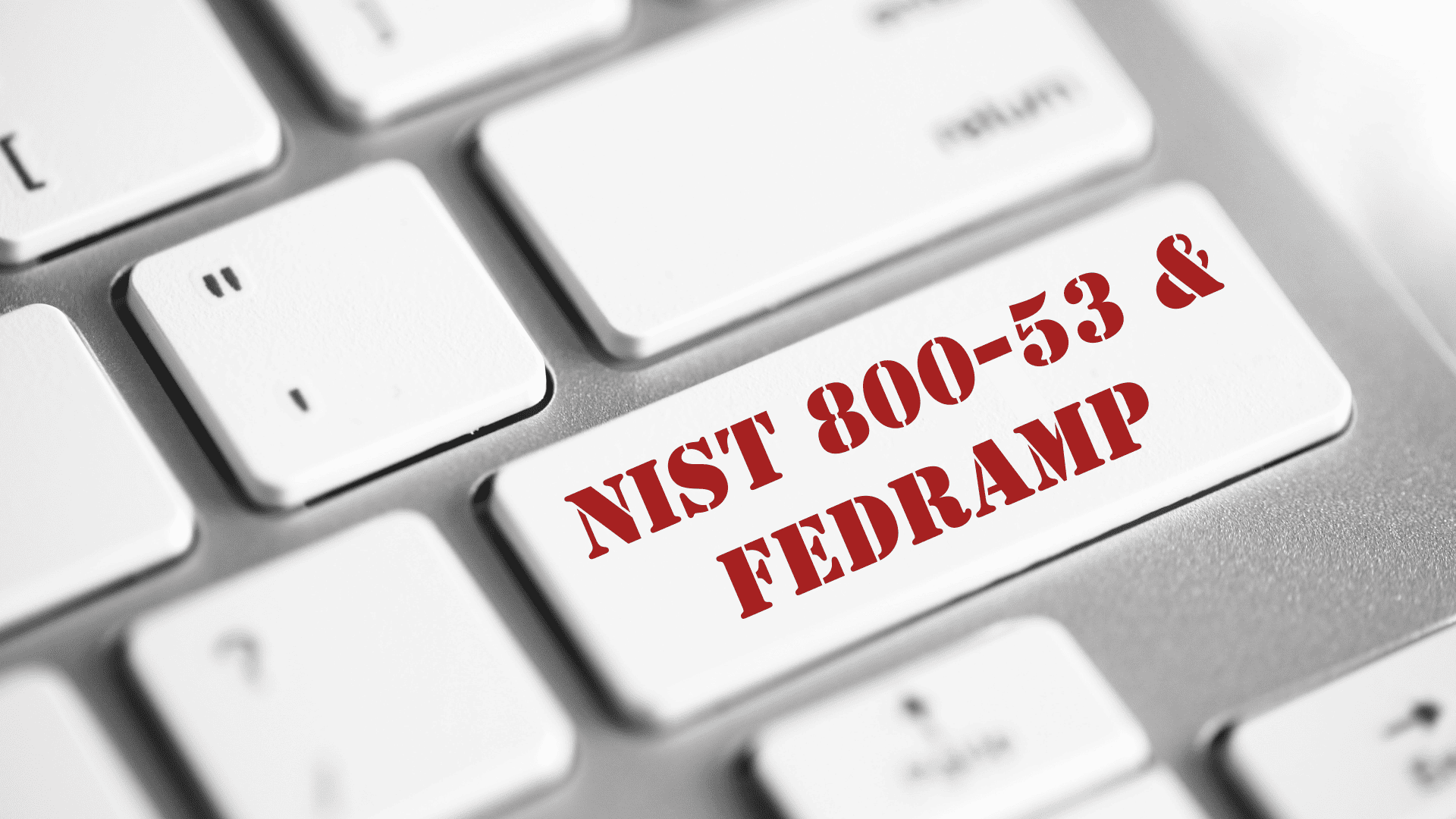 Close-up of a white keyboard with "NIST 800-53 & FedRAMP" stamped in red lettering on the return key.