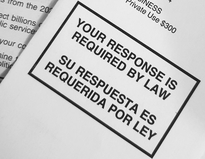 Close-up of a government mailing displaying "Your Response Is Required By Law" in English and Spanish within a bordered box.